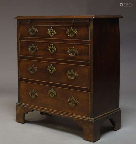 A George III mahogany bachelor's chest, with brushing slide over four long graduated drawers, raised