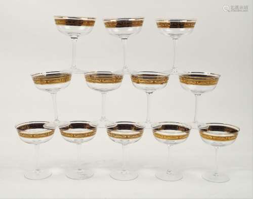 A set of twelve modern champagne glasses, the bowls of circular tapering form, to a plain polished