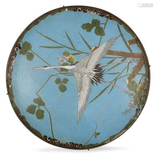 A Japanese cloisonné dish, early 20th century, decorated with a crane in flight amongst floral