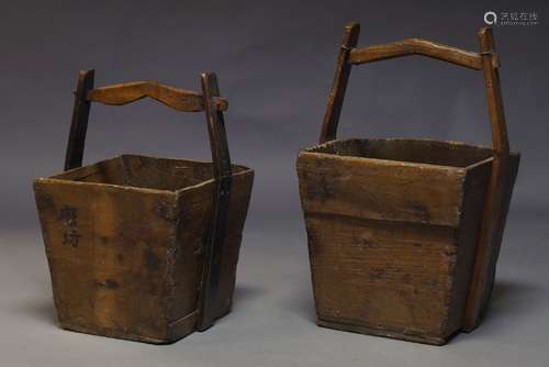 A pair of Chinese hardwood rice buckets, of rectangular form with arching handle and metal bosses,