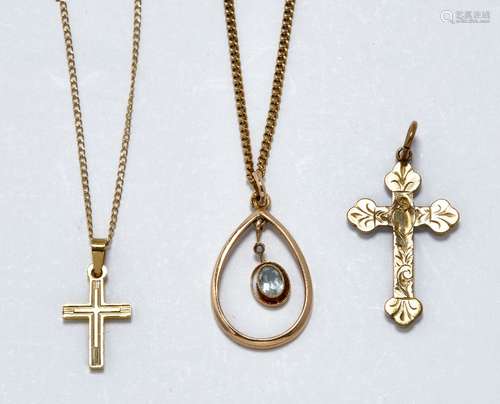 A group of three necklaces comprising: a cross pendant necklace, stamped 14k, pendant length (inc.