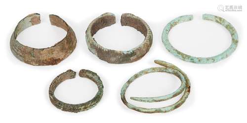 Five Chinese bronze bracelets, Neolithic period, three with woven decoration, 4cm - 6.5cm diameter