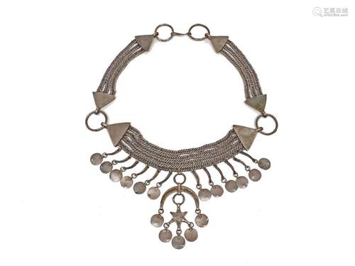 An Near Eastern Islamic style white metal necklace, designed as four curb-link chains, suspending