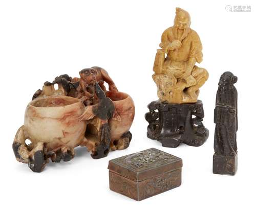 A Chinese soapstone carving of Shou Lao, early 20th century, carved seated and tugging his beard,