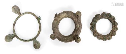 Three large Chinese bronze bracelets, Neolithic period, each cast with spherical knops, 9cm - 16cm