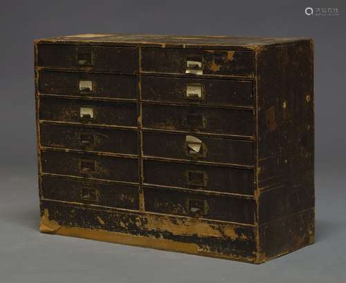 A desk top cabinet, early 20th Century, covered in faux leather effect paper, with two banks of