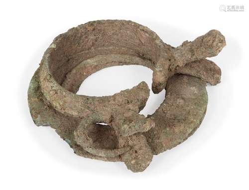 Two Chinese bronze bracelets, Neolithic period, now fused as one, 9cm diameterTwo Chinese bronze