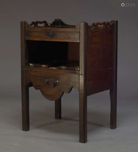 A George III mahogany tray top commode, the shaped gallery top with pierced grips, above single