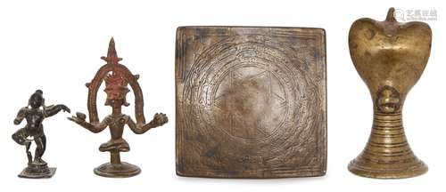 A brass cobra-head lingham, a small bronze figure of Krishna dancing, a bronze tantric plaque and