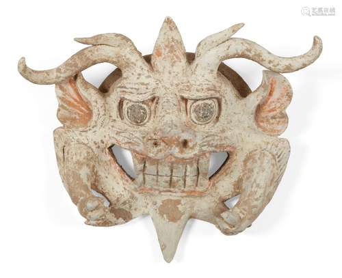 A Chinese terracotta mask with the face of a threatening beast, Tang dynasty, the horned beast