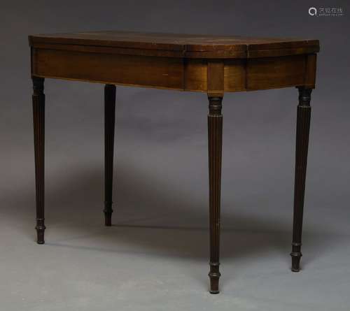 A Regency mahogany and boxwood strung tea table, the fold over top, on reeded and tapering