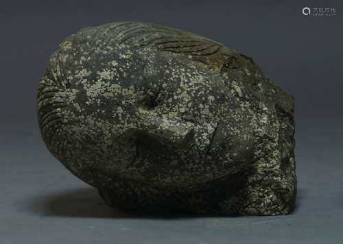 A large carved stone head, early 20th century, modelled as a sleeping lady, 30cm high, 35cm longA