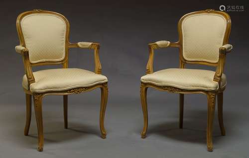 A pair of Louis XV style beech fauteuils, late 20th Century, the top rails with carved foliate