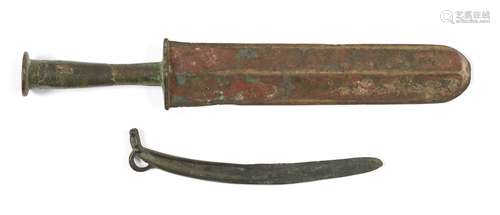 Two Chinese bronze knives, Warring States period and later, one with double-edged rounded blade,