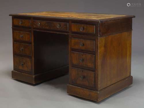 A late Victorian mahogany pedestal desk, the rectangular top inset with brown leather writing