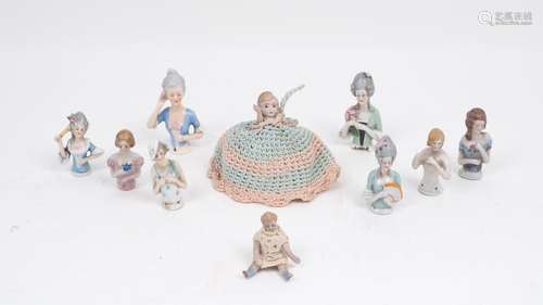 A collection of eight porcelain tea cosy dolls, of various different colour ways and designs,