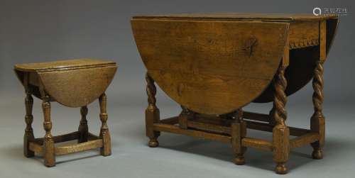 An oak gateleg table, early 20th Century, the oval top, with two drop leaves, above single frieze