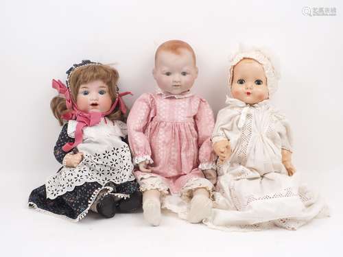 A collection of dolls, 20th century and later, to include: a collectors baby doll, dressed in a pink