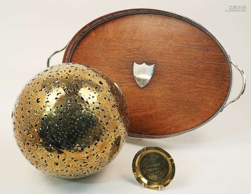 A Chinese brass shadow ball, 19th century, the pierced bird and fauna decorated body enclosing a