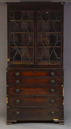 A George IV mahogany secretaire bookcase, the dentil moulded cornice, above astragal glazed doors