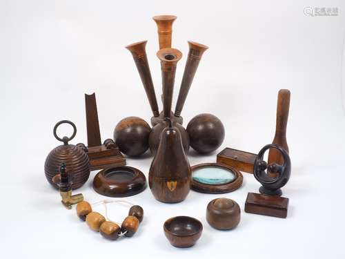 A collection of carved treen items, 19th century and later, to include a turned lignum vitae spill