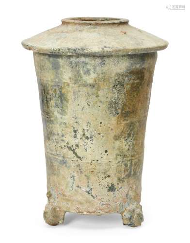 A Chinese pottery green-glazed granary jar, Han dynasty, the sloped cover incised with two chevron