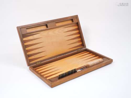 A walnut travelling backgammon board, 20th century, of typical form, the quarter cut veneered