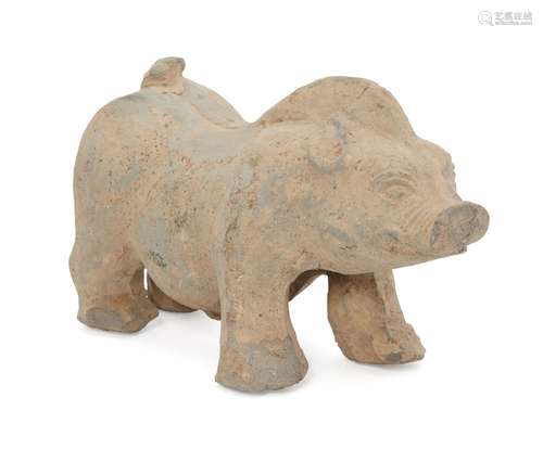 A Chinese grey stoneware model of a pig, Han dynasty, modelled standing four-square with upturned