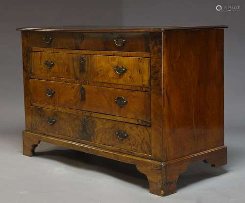 A figured walnut chest of drawers, 19th Century and later, with four graduated drawers, raised on