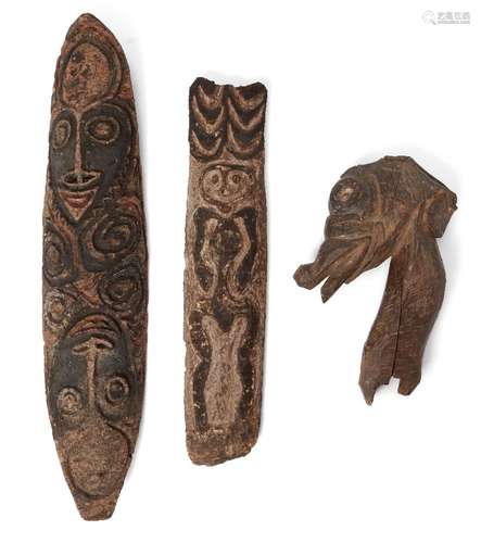 A Pacific Island carved wood plague/mask, possibly Polynesian, 83cm long, a further example,