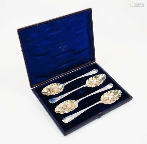A cased set of four matched berry spoons, spurious marks, assumed silver, the repousse gilded