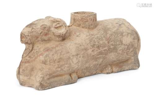 A Chinese grey pottery zoomorphic vessel, Han dynasty, modelled as a recumbent ram with traces of
