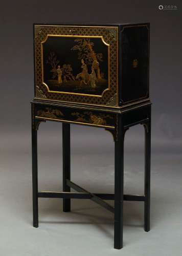 A black lacquered and Japanned cabinet on stand, early to mid 20th Century, the fall decorated
