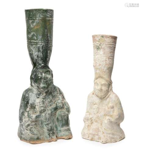 Two Chinese pottery figural candle holders, Han dynasty, each modelled as a seated figure holding