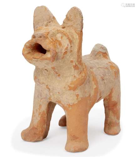 A Chinese pottery model of a dog, Han dynasty, standing foursquare with its head raised in alert