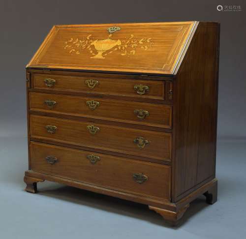 A George III mahogany and inlaid bureau, the fall with marquetry inlaid urn and foliate