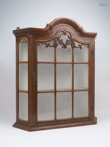 A Dutch taste wall mounted display cabinet, 20th century, with domed top and canted corners, with
