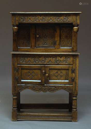 A 17th Century style dwarf oak court cupboard, early 20th Century, with overall carved decoration,