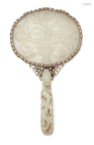 A Chinese greenish-white jade plaque and belt hook, 18th century, now mounted to form a hand mirror,