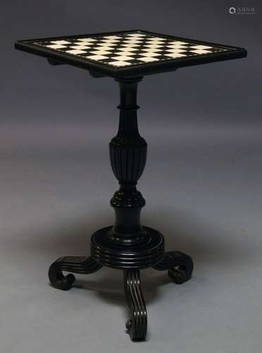 An Anglo Indian ebony and ivory inlaid chess table, the square top on turned and reeded support,