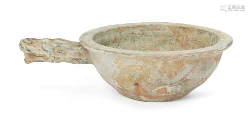 A Chinese pottery grain scoop, Han dynasty, covered in a green glaze, with everted rim and dragon'