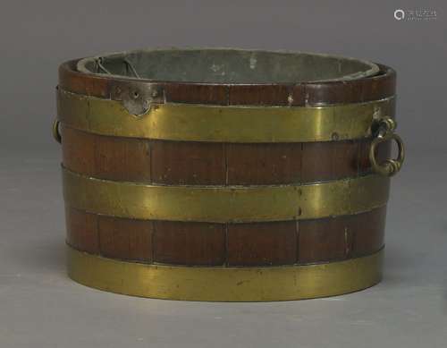 A George III mahogany and brass bound wine cooler, of tapered cylindrical form, with later lead