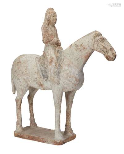 A Chinese pottery horse and rider, Tang dynasty, standing foursquare on a rectangular base, with