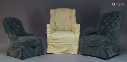 An Edwardian wingback armchair, with cream upholstered slip cover, on square tapering legs to