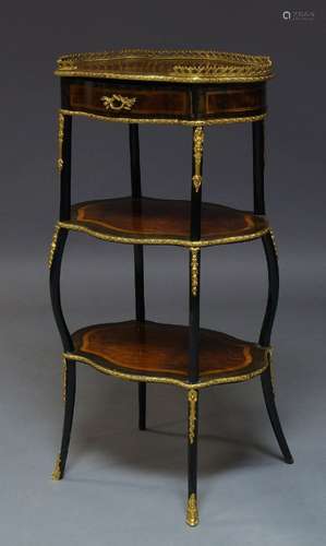 A French walnut, ebonised and gilt metal mounted three tier etagere, late 19th Century, the shaped