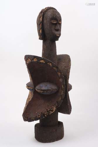 A carved wood African sculpture, 20th century, featuring a double Yoruba style head with carved