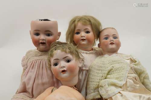 A group of four bisque headed dolls, 20th century and later, in varying conditions, some with