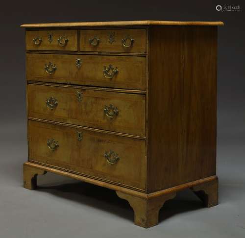 A George II style walnut and feather banded chest of drawers, 20th Century, the quarter veneered top