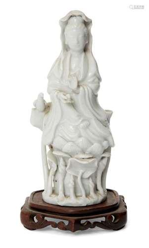 A Chinese Dehua porcelain figure of Guanyin, 18th century, modelled seated on a lotus base, 13.8cm