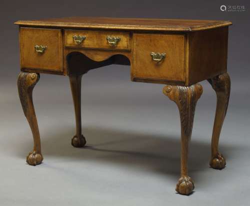 A George II style walnut lowboy, early to mid 20th Century, the rectangular quarter veneered top,